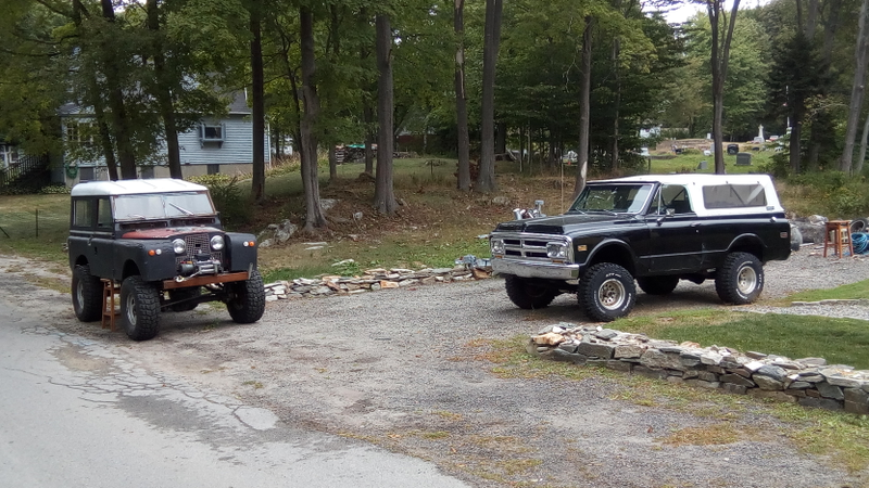 The land rover was running around earlier in the summer. Now the right side is being supported by a bar stool.